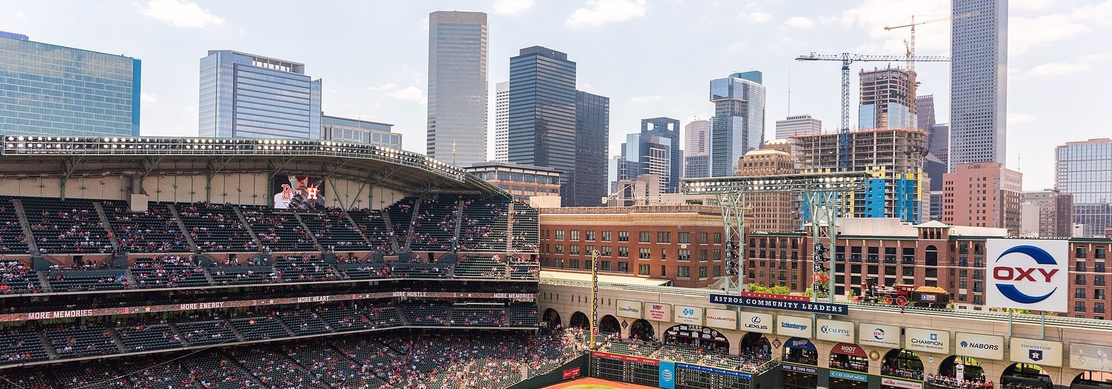 Exterior view of Minute Maid Park with the downtown Houston, Texas skyline rising behind the ballpark - Minute Maid Park tickets
